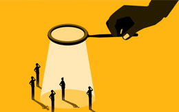 Magnifying glass inspecting men in suits